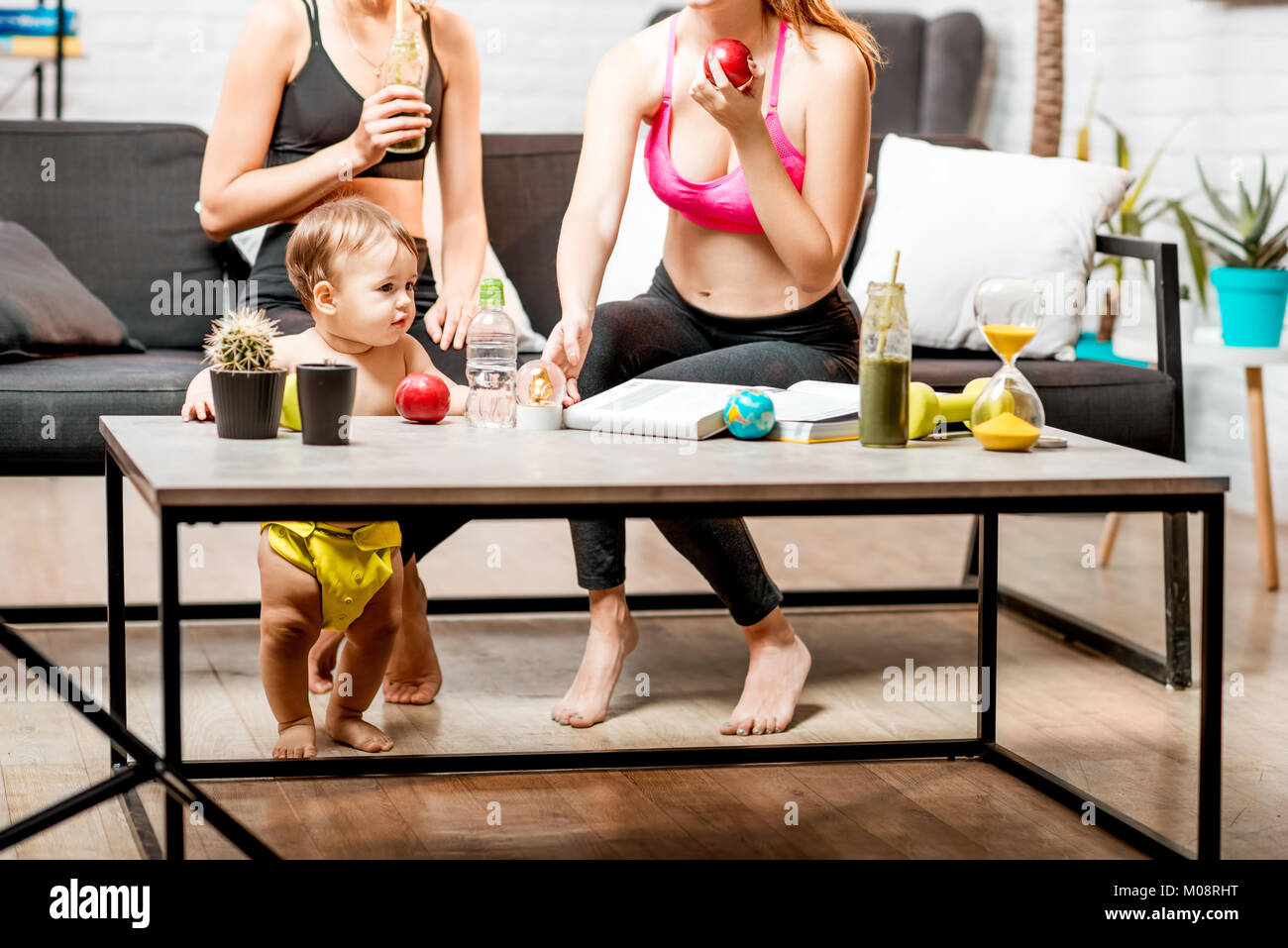 Sports women with baby boy at home Stock Photo