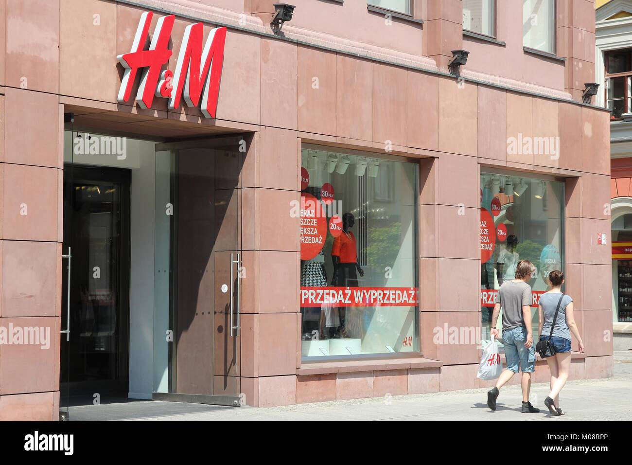 WROCLAW, POLAND - JULY 6, 2014: People shop at H&M fashion store in Wroclaw.  H&M is an international fashion retail corp known for its fast fashion ap  Stock Photo - Alamy
