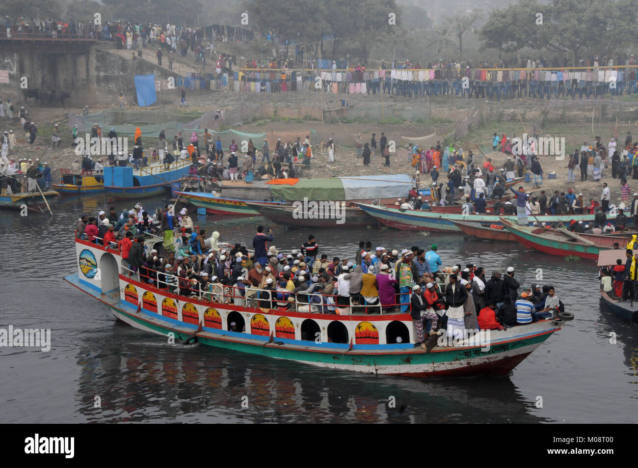 Bangladeshi Muslim devotees return home in an over-crowded boat after attends the Akheri Munajat or the Final Prayer on the last day of Biswa Ijtema,  Stock Photo