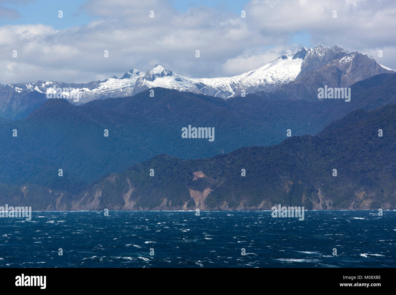 The Snowy Mountain Peaks In Fiordland National Park New Zealand Stock the-snowy-mountain-peaks-in-fiordland-national-park-new-zealand-stock