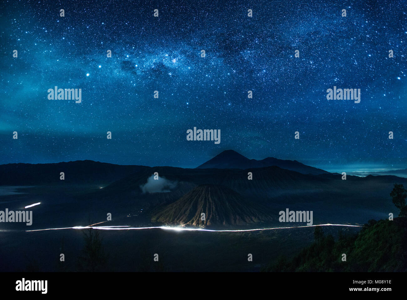 Dreamy view of Mount bromo and millions stars in the sky at night, Indonesia Stock Photo