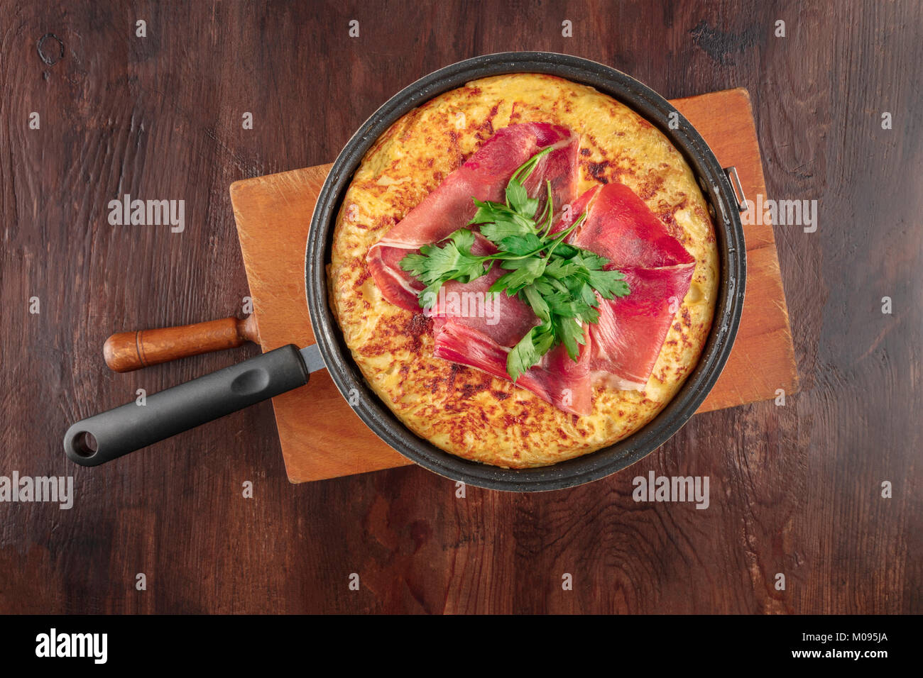 An overhead photo of a Spanish tortilla in a traditional frying pan
