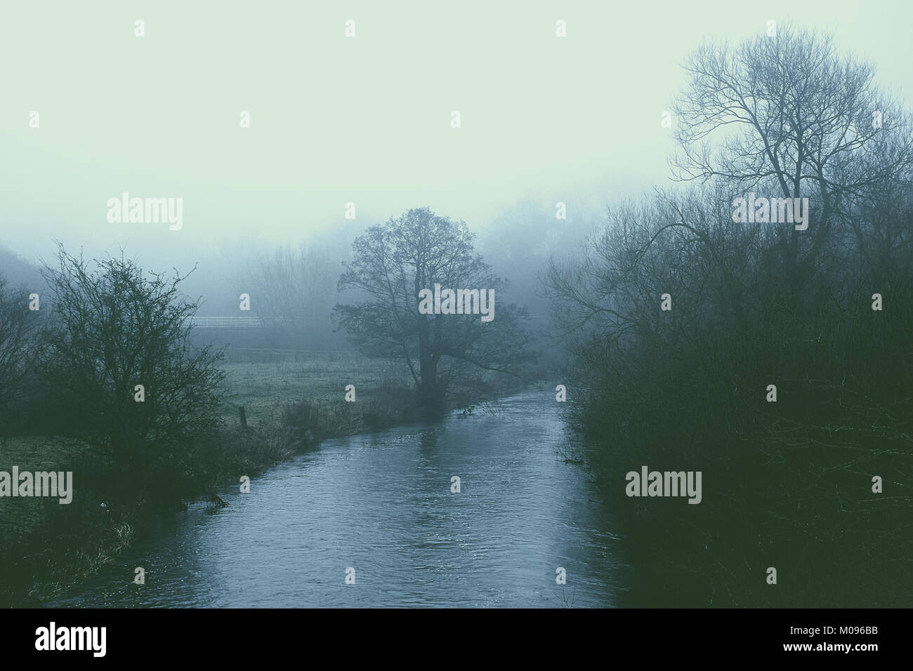 Fog over River Trent on misty winter morning,dark and moody Staffordshire landscape,Staffordshire,United Kingdom. Stock Photo