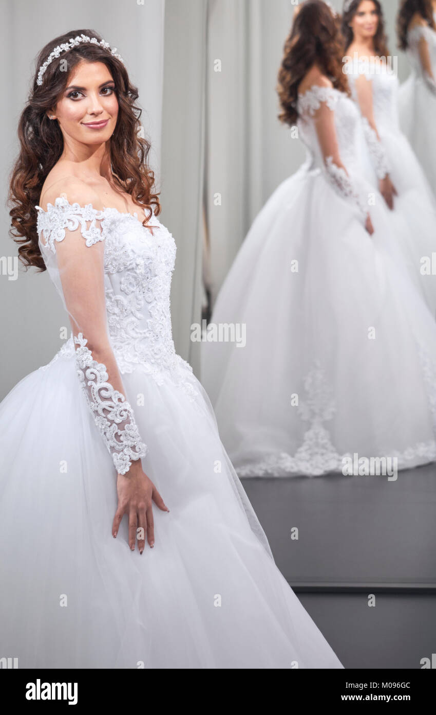 satisfied young bride, one person, looking at self, in mirror, happy Stock Photo