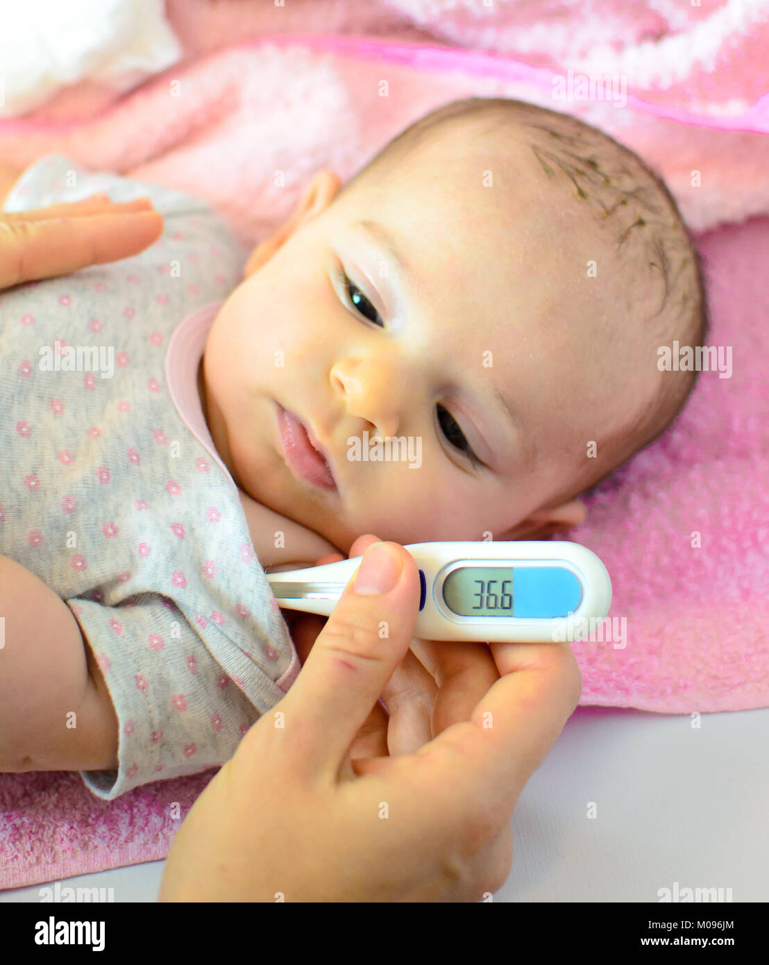 newborn thermometer measures temperature fever flu Stock Photo