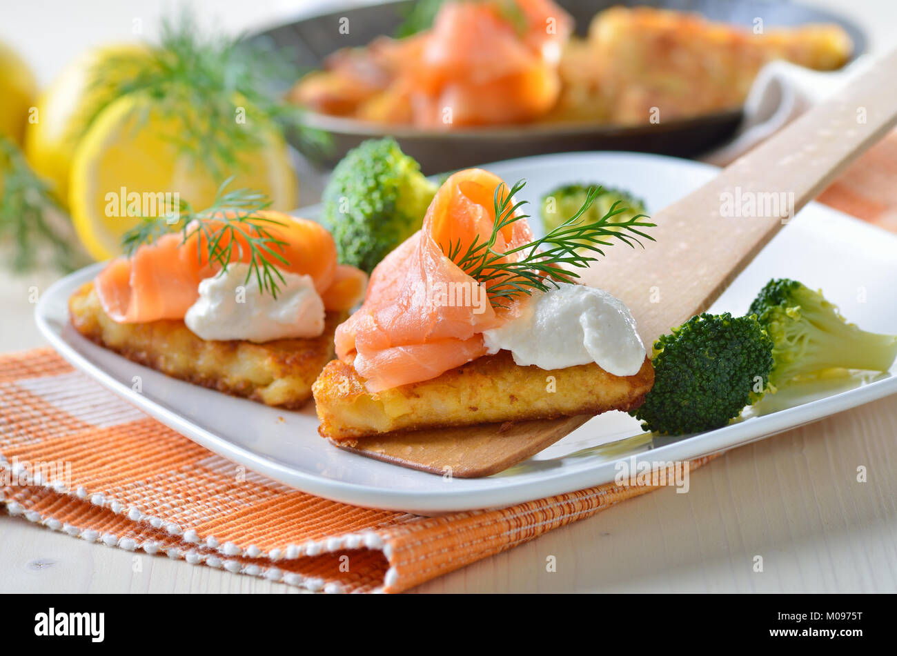 Grated fried potatoes with smoked salmon and creamed horseradish sauce Stock Photo