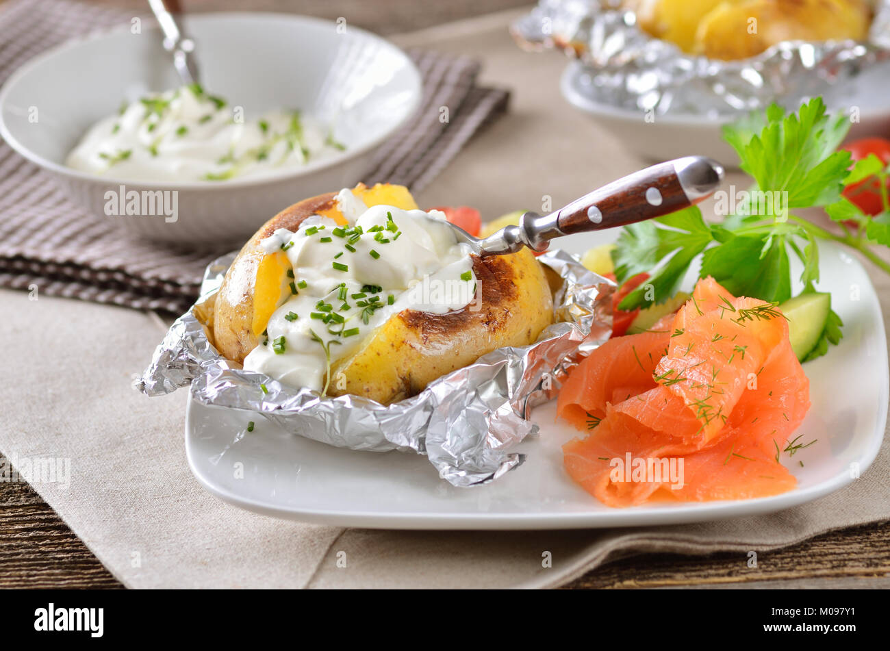 Jacket potato with sour cream, herbs and smoked salmon Stock Photo Alamy