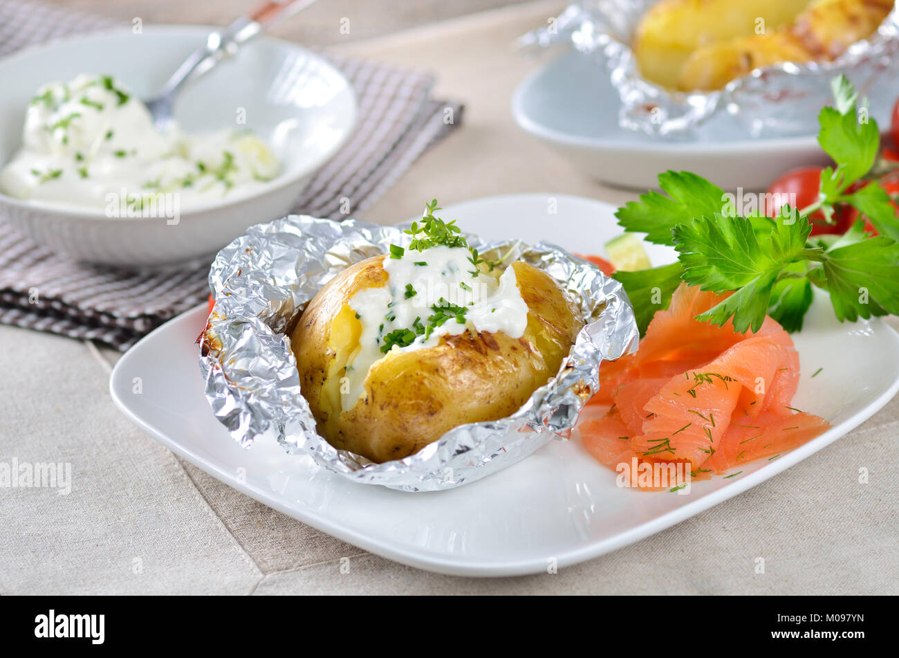 Jacket potato with sour cream, herbs and smoked salmon Stock Photo Alamy