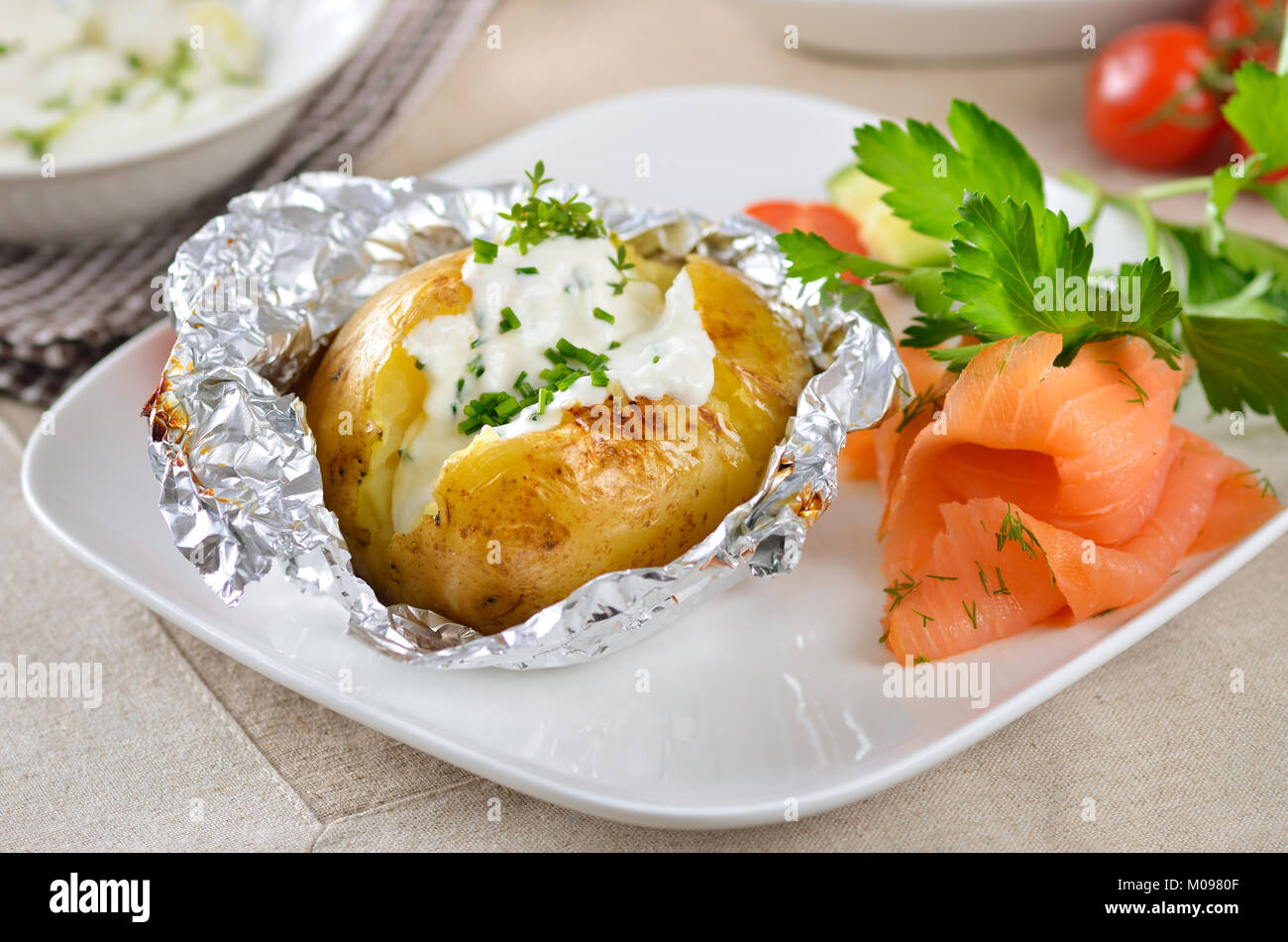 Jacket potato with sour cream, herbs and smoked salmon Stock Photo Alamy