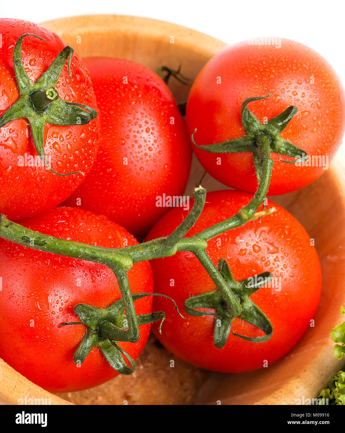 Fresh red vine tomatoes in a wood bowl on the table Stock Photo - Alamy