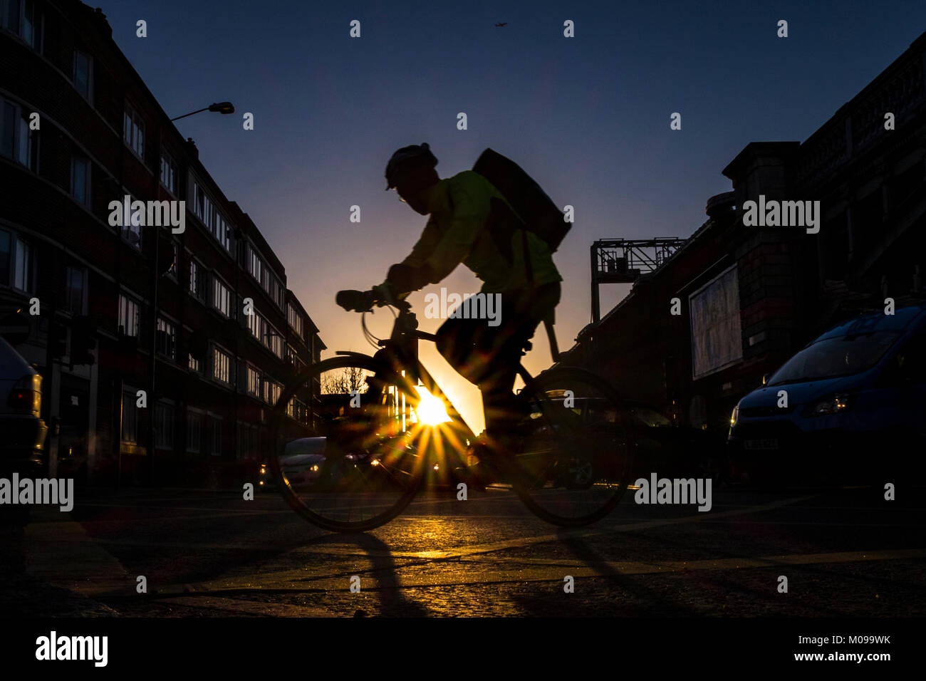 Cyclists commute through London Bridge on a cold but clear Winter day in the capital Stock Photo