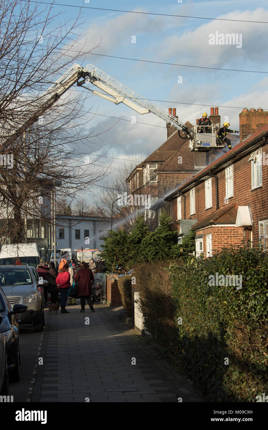 Dagenham, UK. Friday 19th January 2018. Dagenham - house fire 19 January 2018 Eight fire engines and 58 firefighters and officers attended a fire at a terraced house in Lodge Avenue, Dagenham this afternoon. The ground floor, first floor and roof were completely destroyed by the fire. Half of the roof of the adjoined neighbouring property was also damaged by the blaze.  The Brigade was called at 1401 and the fire was under control by 1529. Credit: HOT SHOTS/Alamy Live News Stock Photo