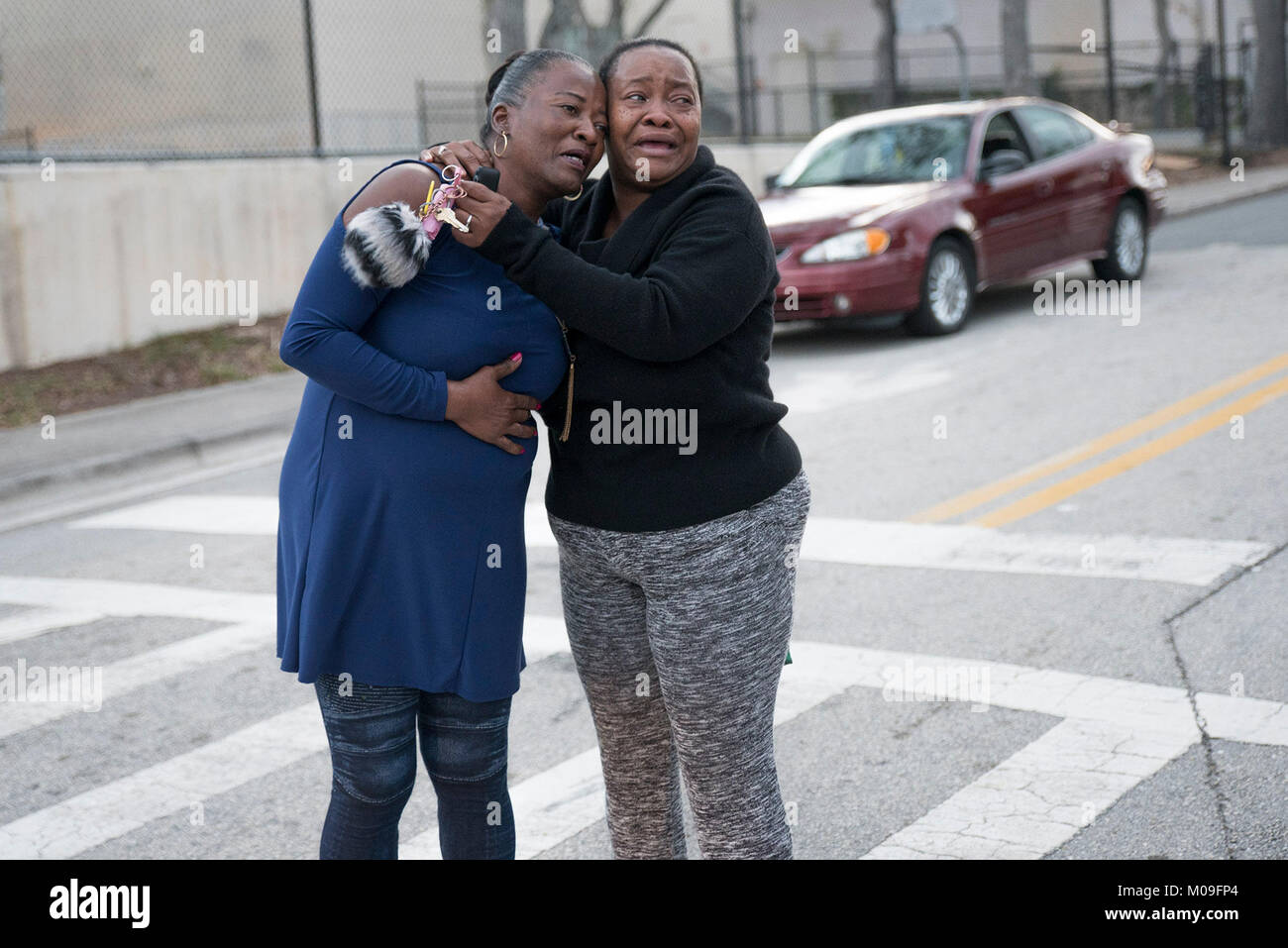 West Palm Beach, Florida, USA. 19th Jan, 2018. Dorothia Patterson, 44, right, hugs her friend, who did not wish to be named, at the scene of a shooting that left one dead and one injured on the corner of Palm Beach Lakes Boulevard and North Sapodilla Avenue on Friday, January 19, 2018. Patterson said the man who was killed was her best friend. ''I didn't want to believe it, I didn't want to accept it. It's just another good life lost to senseless violence, '' Patterson said. Credit: Andres Leiva/The Palm Beach Post/ZUMA Wire/Alamy Live News Stock Photo