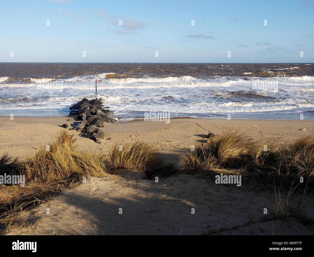 Stormy seas crash on to beach and sea defences at Horsey Gap, Norfolk, site of the famous Horsey Seals colony on a windswept January day. Stock Photo