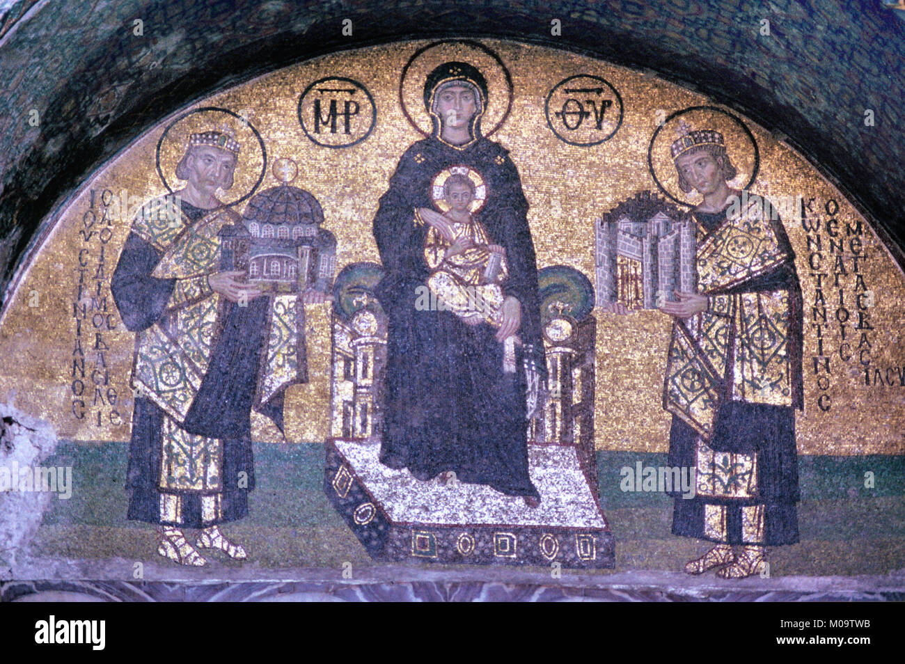 Byzantine Mosaic of Byzantine Emperor Justinian I (c482-565) aka Saint Justinian the Great Holding a Model or Offering of the Hagia Sophia Church (to left) and Emperor Constantine the Great (to right) offering a Model of Byzantium or Constantinople to Virgin Mary in the Hagia Sophia Church Museum, Sultanahmet, Istanbul, Turkey Stock Photo