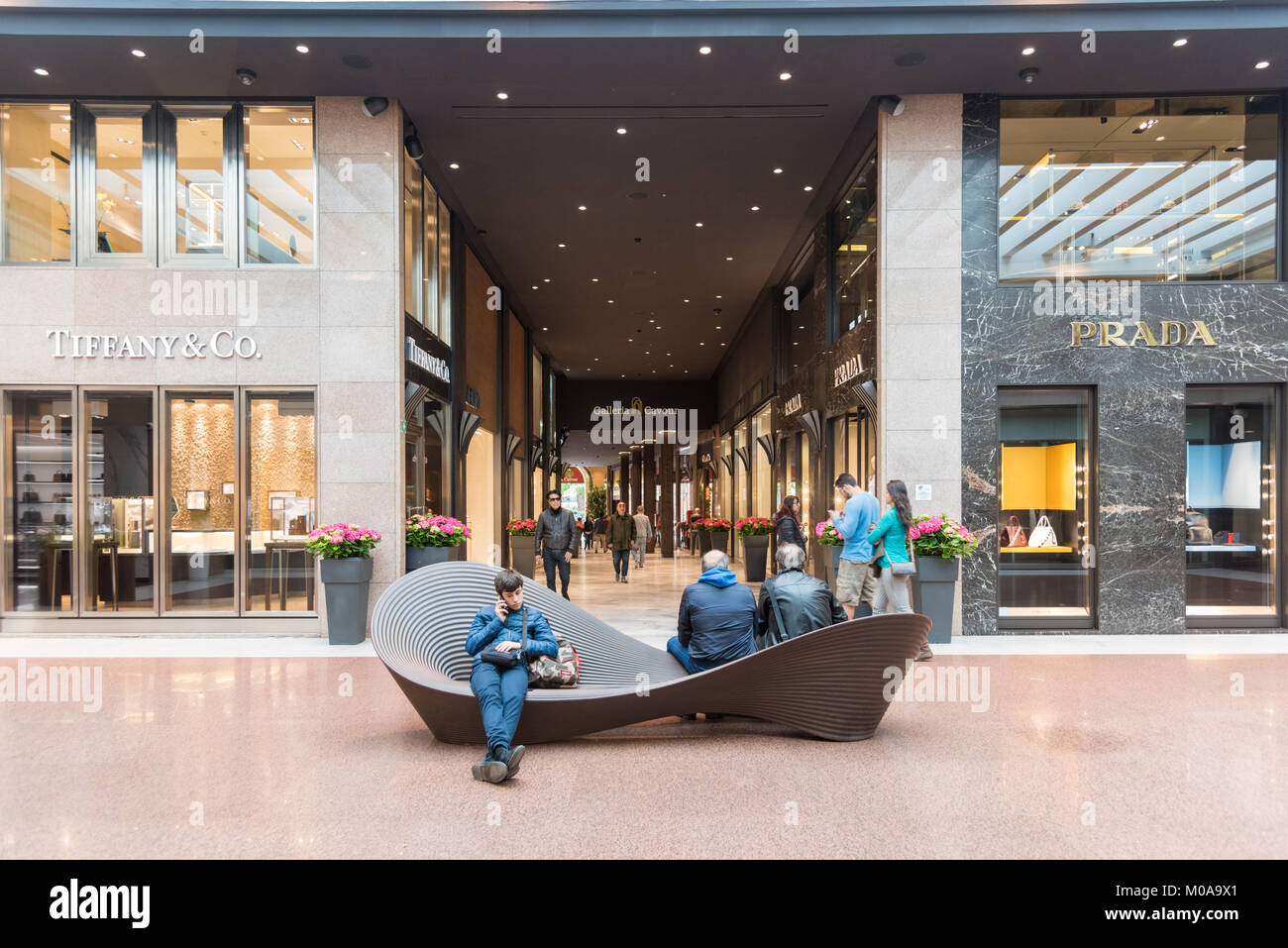 People in the luxury designer shops in the Galleria Cavour shopping mall Bologna Italy Stock Photo