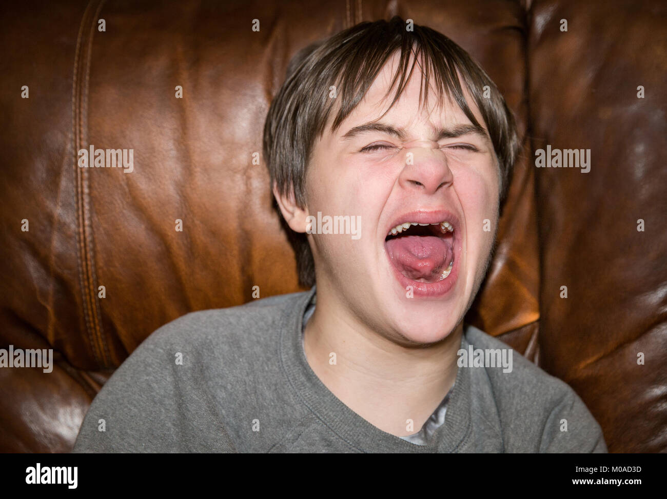 Teenage boy with Autism and Down's Syndrome has a meltdown Stock Photo