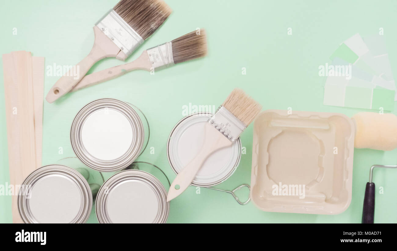 Supplies to start house painting project. Metal paint cans, paint ...