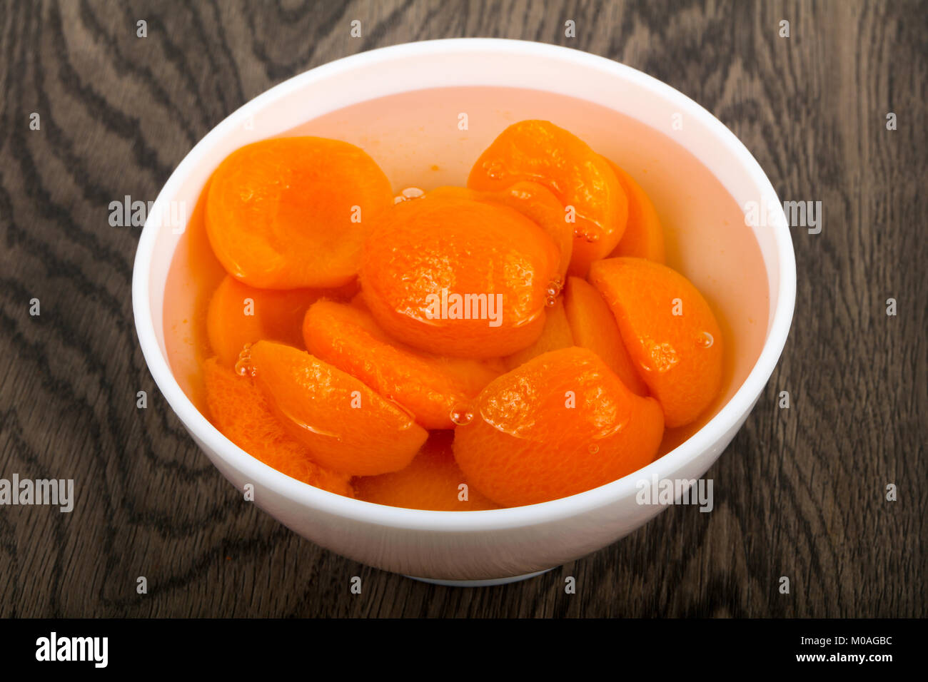 Canned apricots with mint leaves Stock Photo Alamy