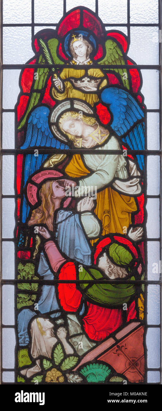 LONDON, GREAT BRITAIN - SEPTEMBER 19, 2017: St. John the Evangelist at the vision of angels from Apokalipse on the stained glass in St Mary Abbot's Stock Photo