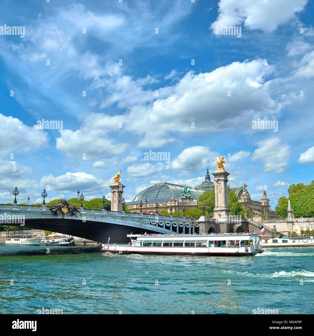 Paris, France, passenger boat passes under Alexander III bridge on Seine river in Spring. Panoramic image, square composition. Stock Photo