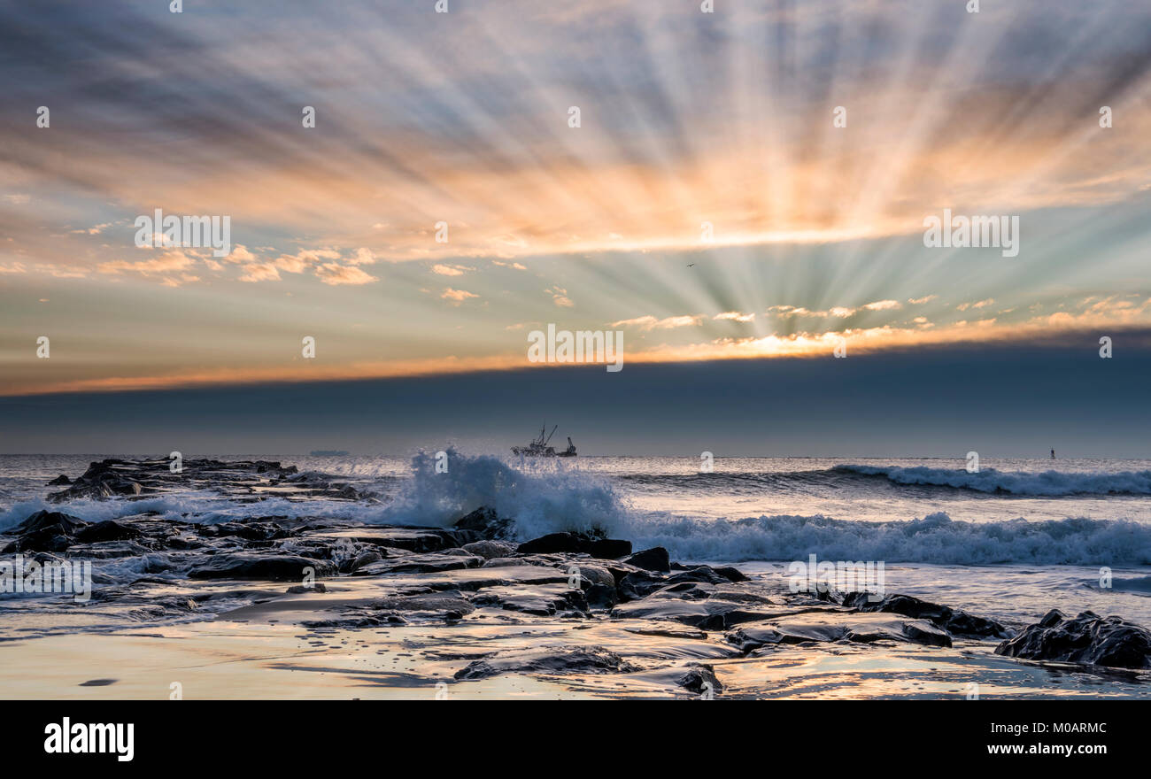 Beautiful sun rays during sunrise at Jersey Shore. Avonbythesea, New