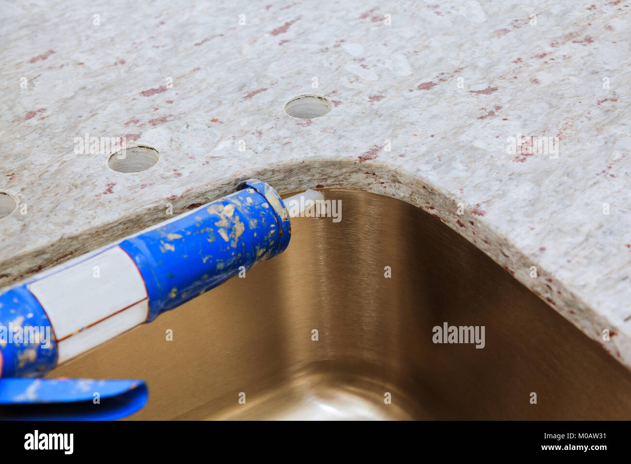 Contractor installing counter tops, and sink are partially installed