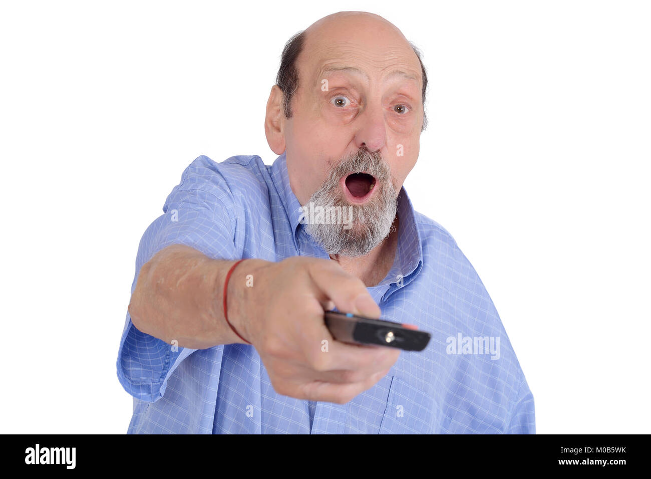 Shocked senior man watching tv with remote control. Entertainment concept. Isolated white background Stock Photo