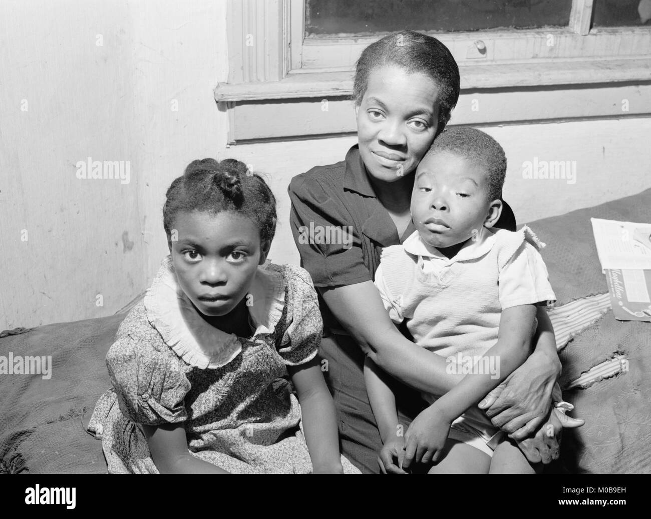 African American Mother and two children. Family is on relief. Chicago