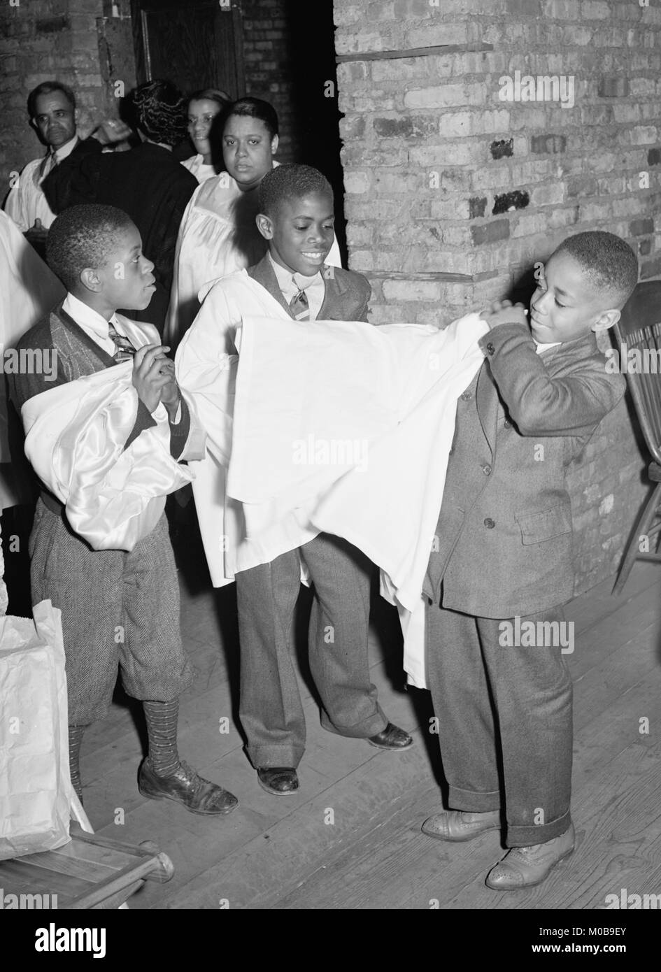 African American Boys of children's choir putting on their robes. Chicago, Illinois Stock Photo