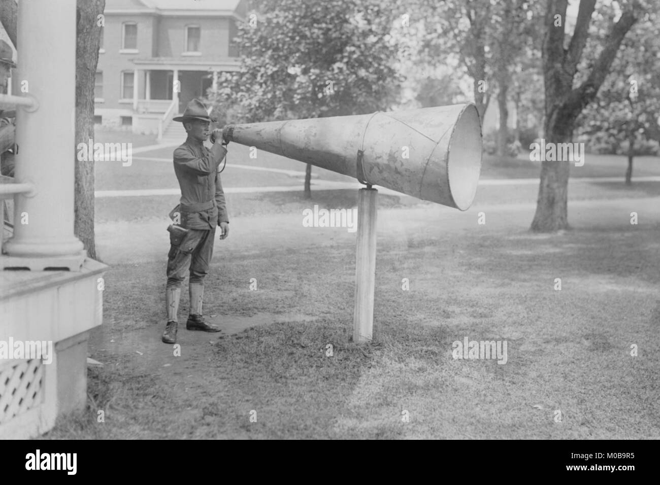 Soldier Plays his bugle into a huge megaphone at Fort Totten, Bayside Queens New York Stock Photo