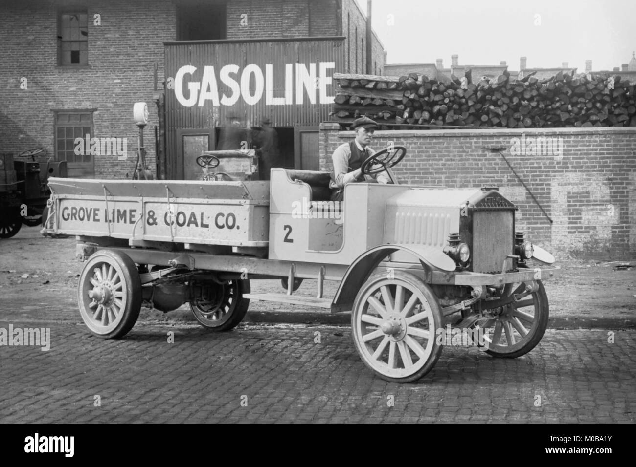Grove Lime & Coal Company in front of a building sign that reads Gasoline Stock Photo