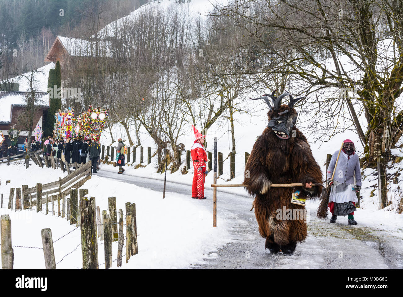 Bad Hofgastein: Perchtenlauf (Percht Perchten mask procession): Vorteufel (front devil), schöne Bajazzl (Hanswurst), Kappenträger mit Nachtänzer (cap  Stock Photo