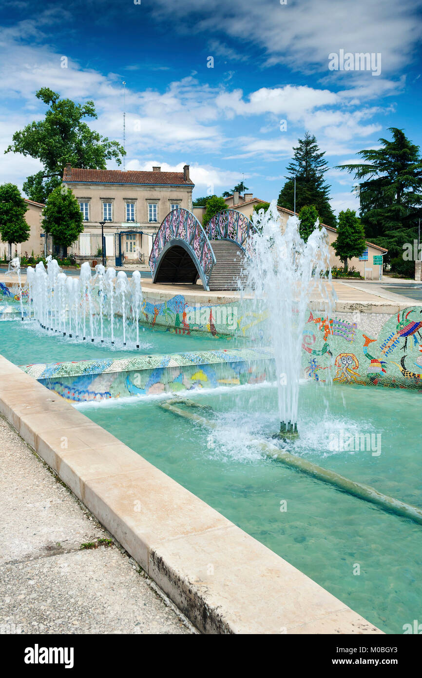 Melle, Deux-Sevres, France - July 7, 2012: Decorative water feature with a bridge and fountains in the centre of Melle Stock Photo