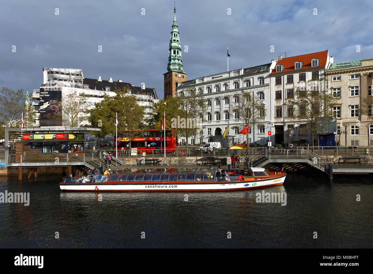 Copenhagen, Denmark - November 7, 2016: Sightseeing bus and tour boat at Ved Stranden street. Sightseeing tours is very popular among tourists Stock Photo