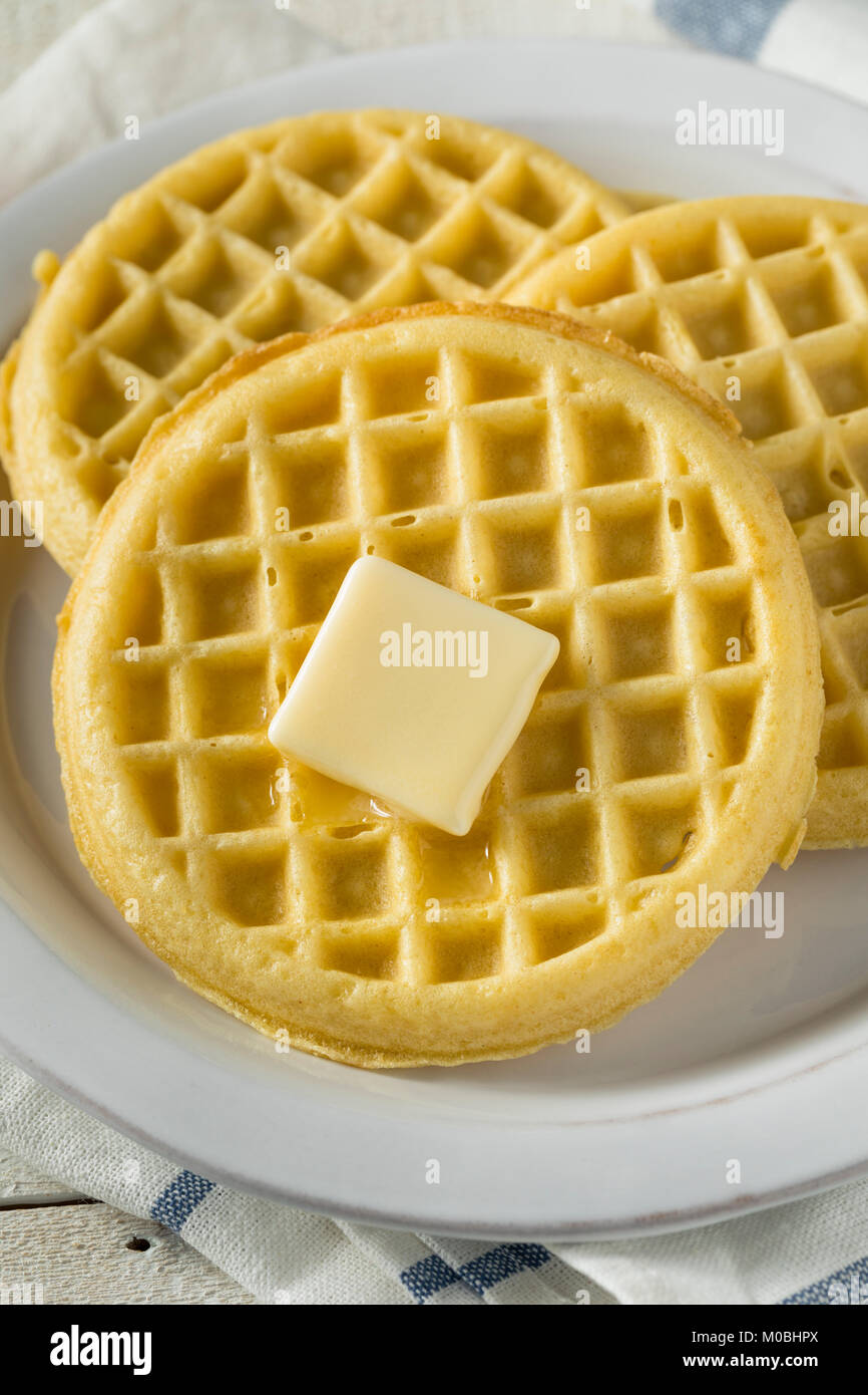 Brown Hot Freezer Waffles with Butter and Maple Syrup Stock Photo