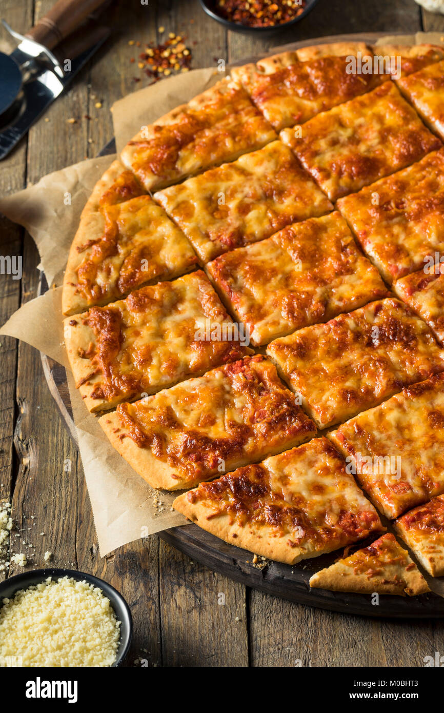 Delicious Homemade Cheese PIzza Cut into Square Slices Stock Photo