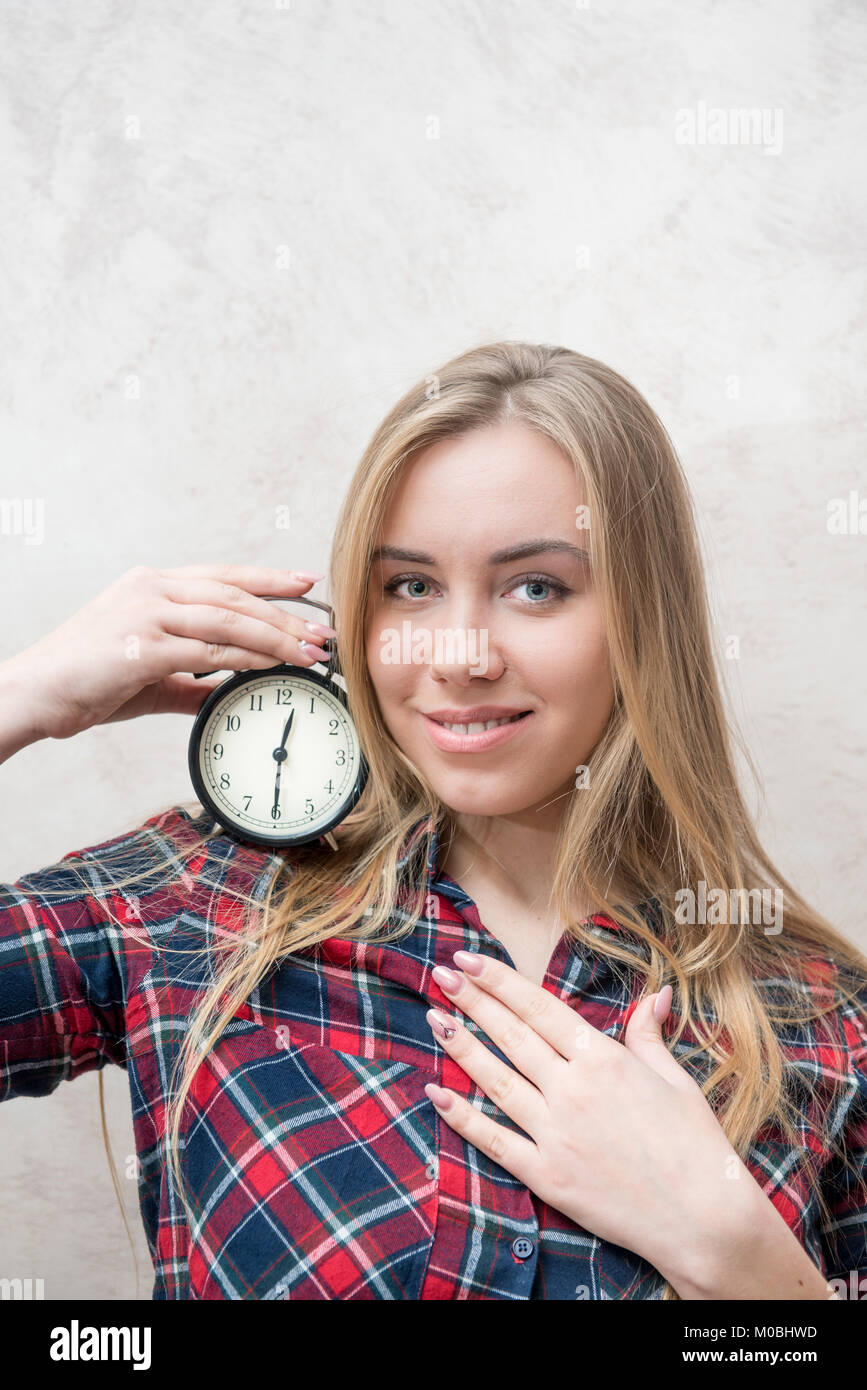Young blond hair woman and alarm clock concept of time, dating, deadline, offer, occasion, event Stock Photo