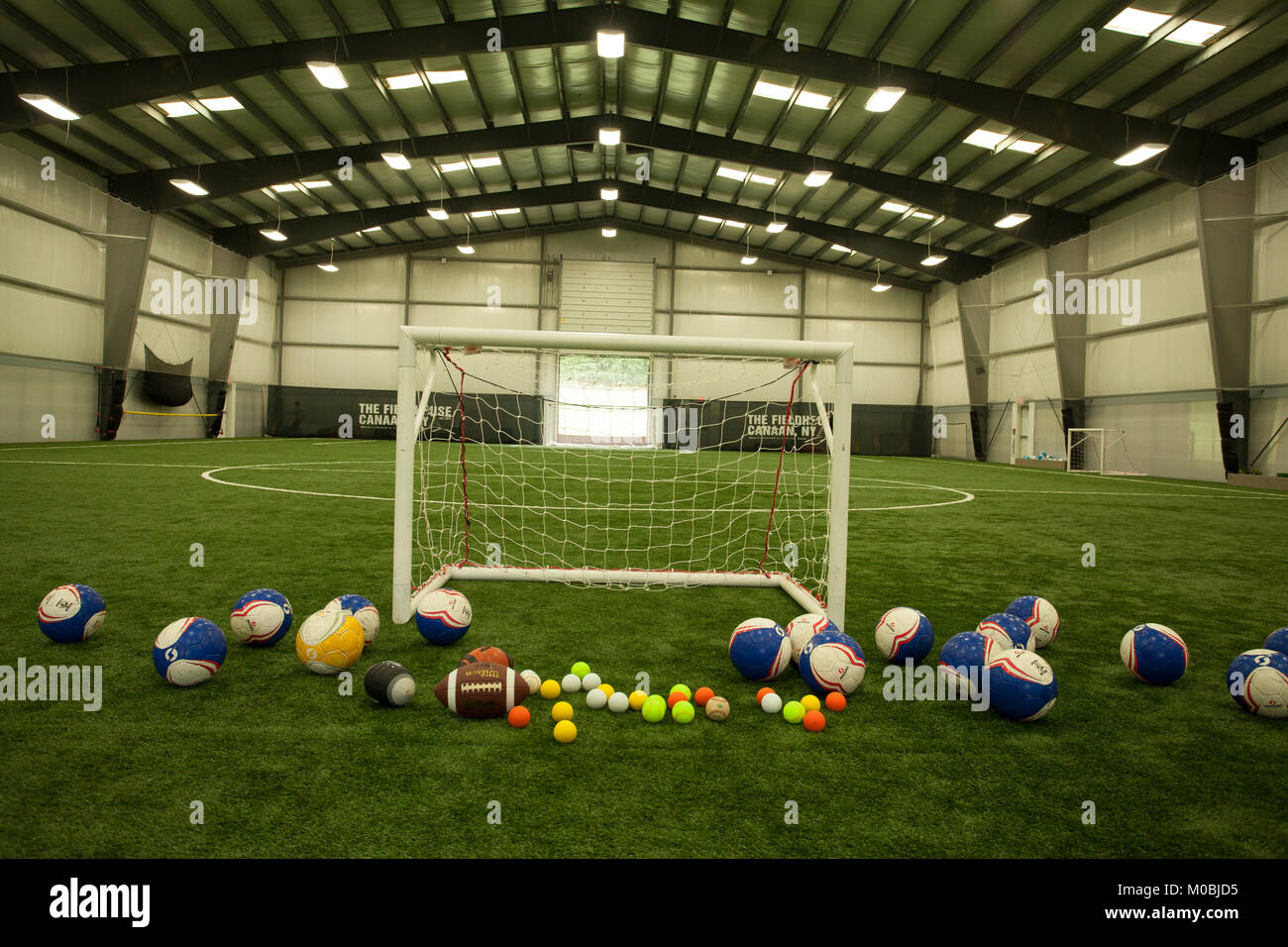 An indoor sports field rented out for practicing various sports. Stock Photo