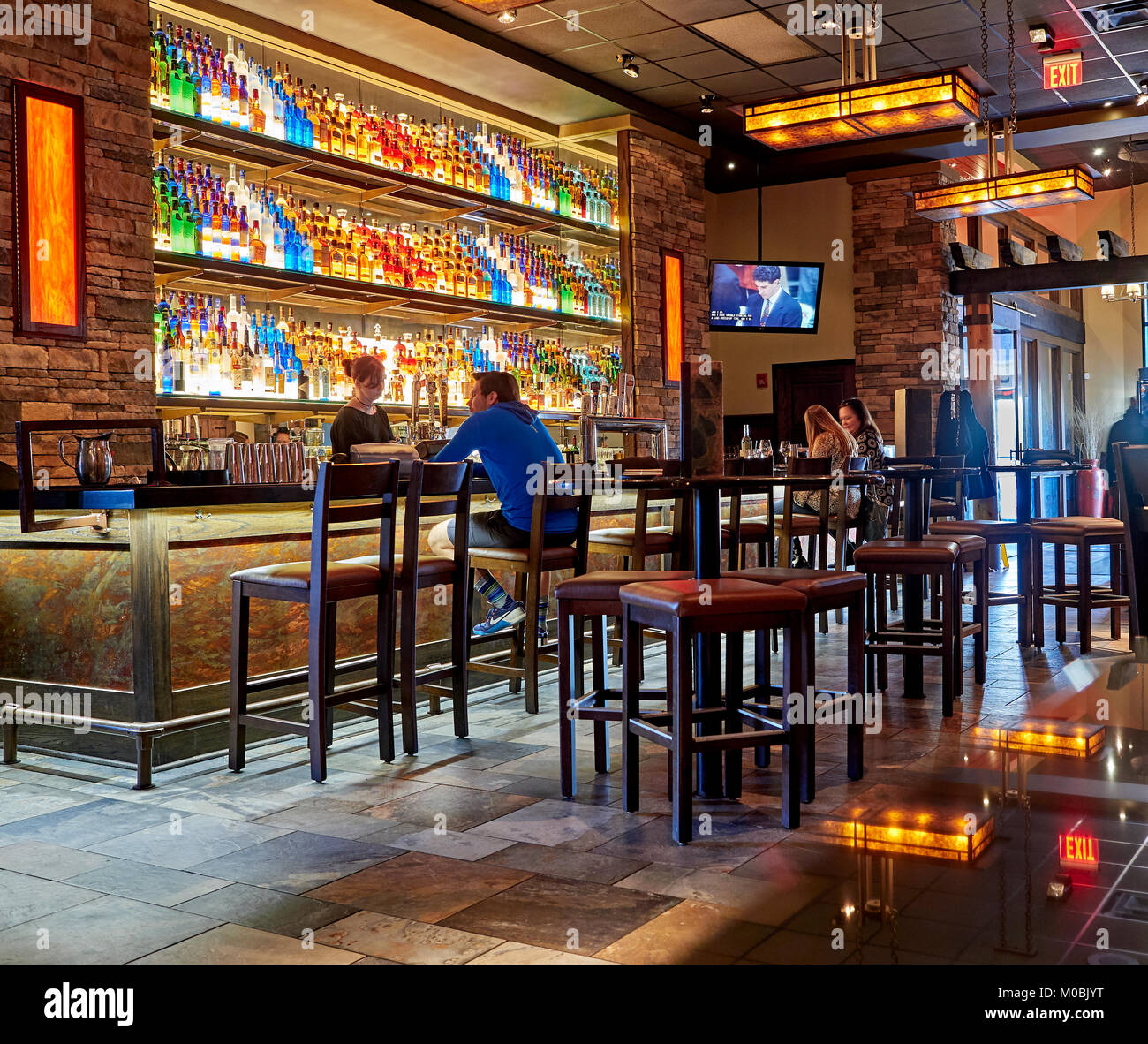 Interior or inside view of the colorful bar, with customers or patrons and bartender, at Firebirds Restaurant, Montgomery Alabama, USA. Stock Photo