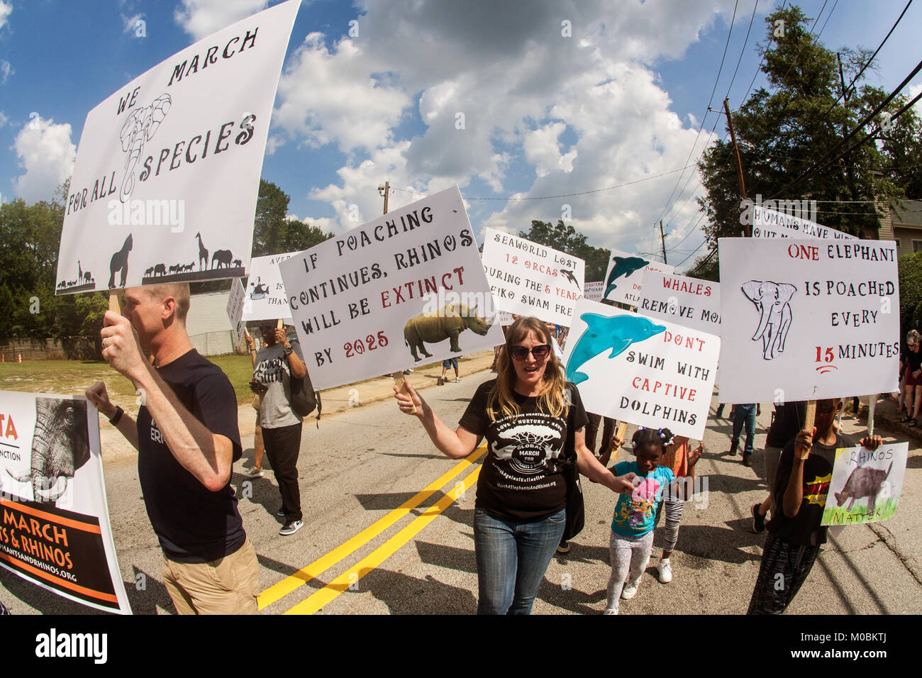 Atlanta, GA, USA - September 23, 2017:  A group of animal rights activists carry signs about rhinos and elephants as they walk in the East Atlanta Str Stock Photo