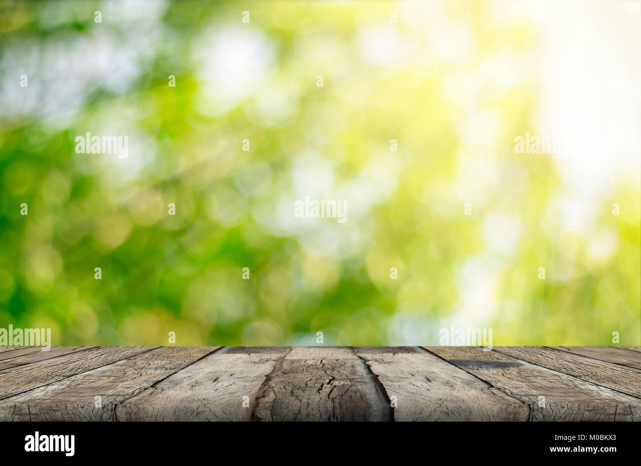 wood table and green leaf bokeh blurred for nature background Stock ...