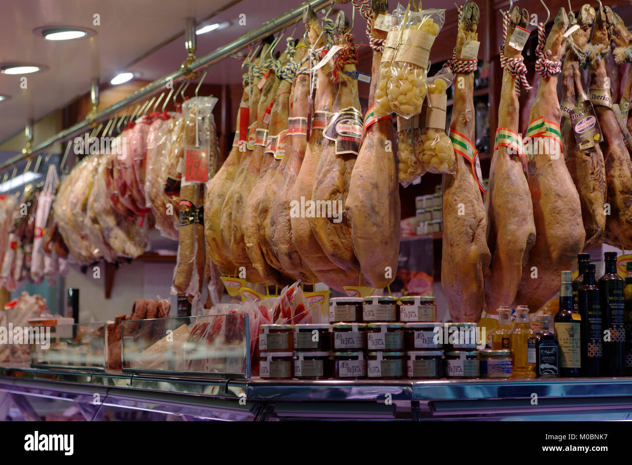 Barcelona, Spain - January 9, 2013: Jamons, sausages, and other meat products in a shop. Traditional Spanish jamon is widely known in the world Stock Photo
