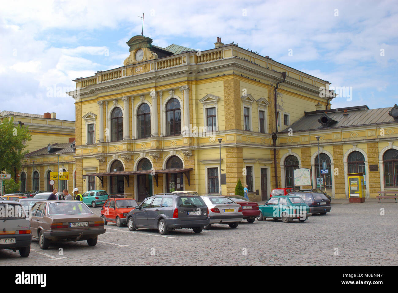 Przemysl, Poland - August 24, 2006: People in front of the main train station. The station opened in 1860 and reconstructed in 1895 in neo-baroque sty Stock Photo