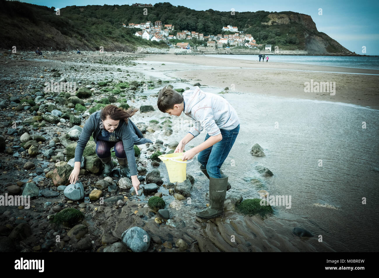 Mother and son, crabbing, fishing, rock pool, Runswick Bay, Yorkshire