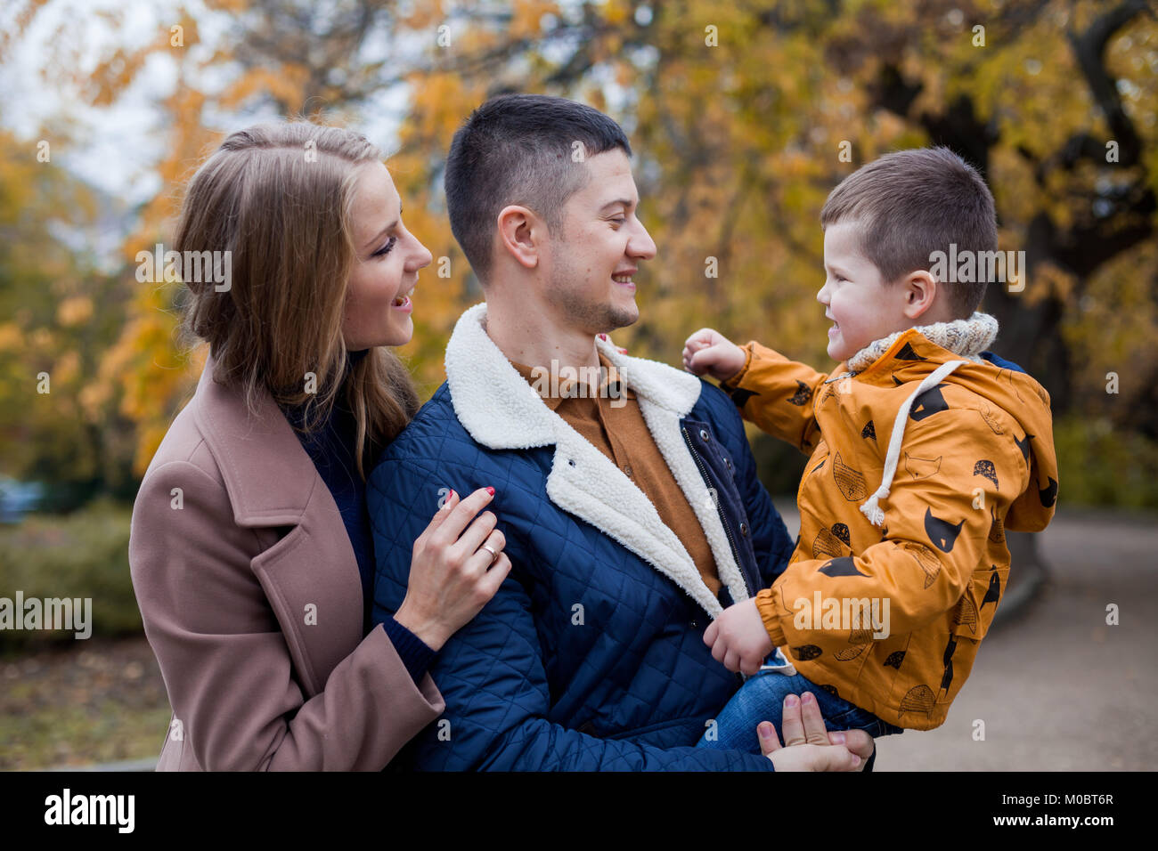 family mom dad son portrait with happiness in the forest Stock Photo - Alamy