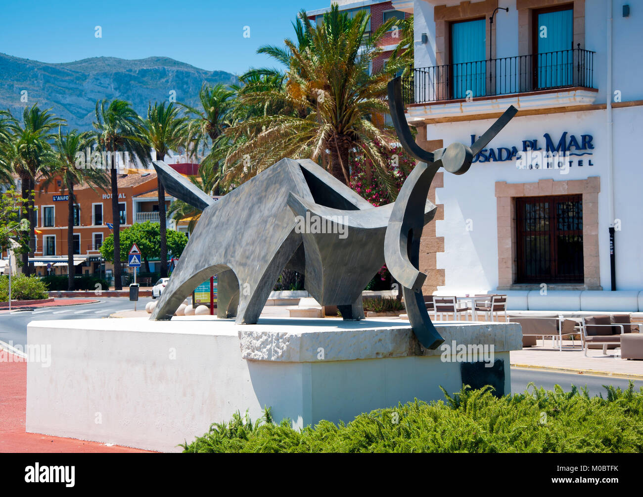 Bull pushing man into the sea statue, Denia, Valencia, Spain Stock Photo