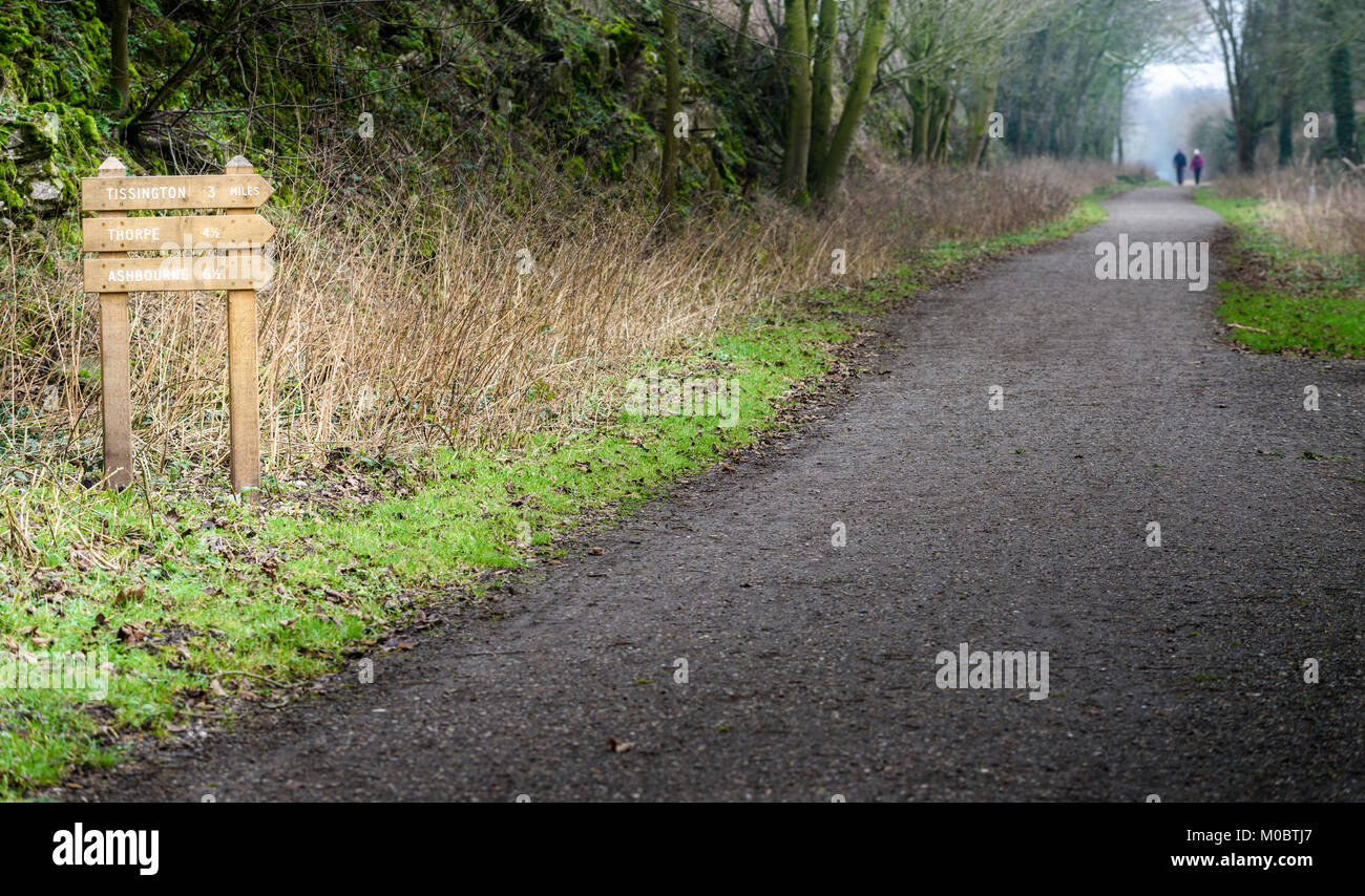 Pair of walkers on the Tissington trail in mid winter on the Peak district at Alsop moor, Derbyshire, England. Stock Photo