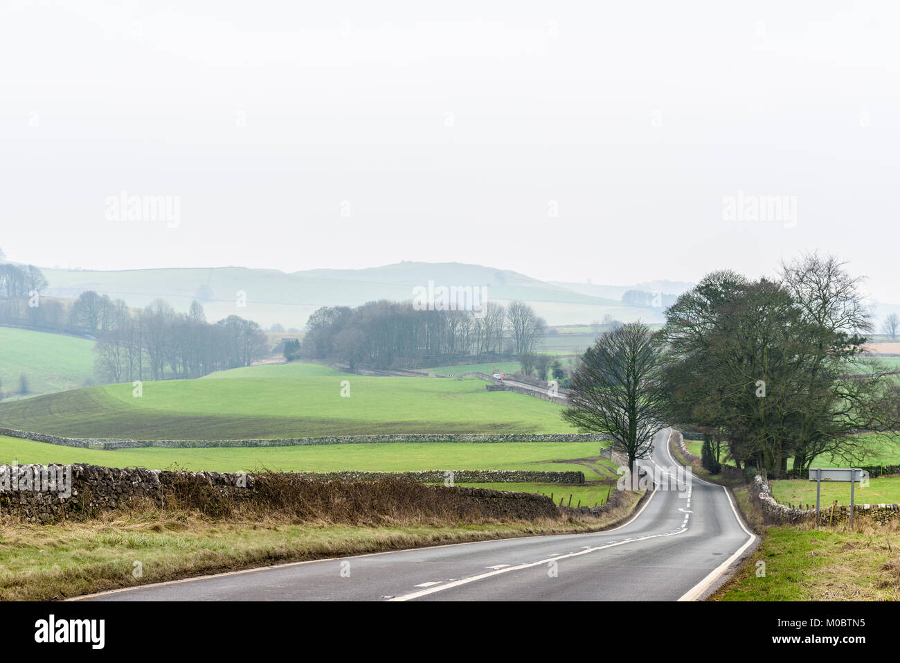 Road to Ashbourne next to the Tissington trail in mid winter on the Peak district at Alsop moor, Derbyshire, England. Stock Photo