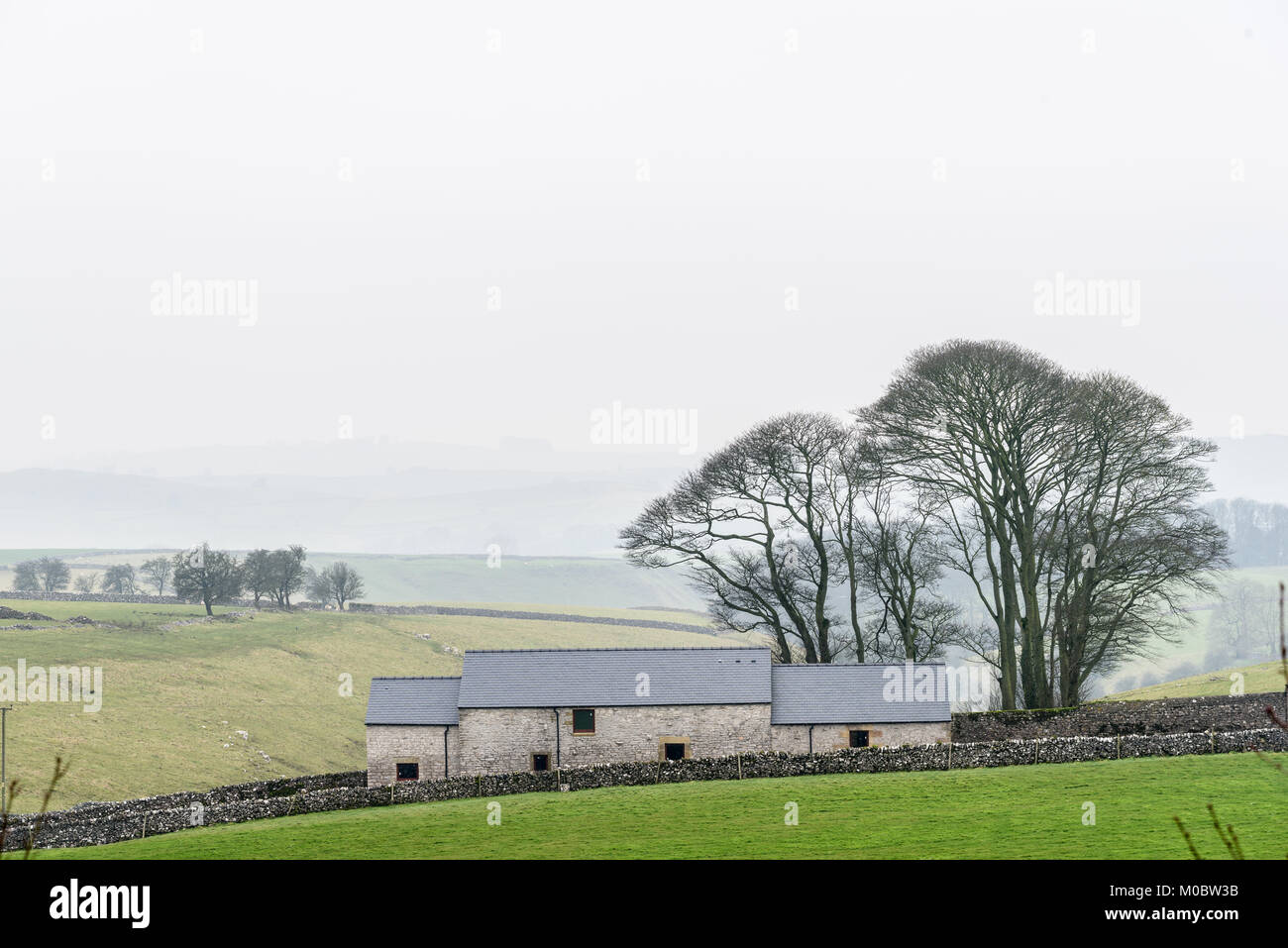 Refurbished farm house as seen from the Tissington trail in mid winter on the Peak district at Alsop moor, Derbyshire, England. Stock Photo